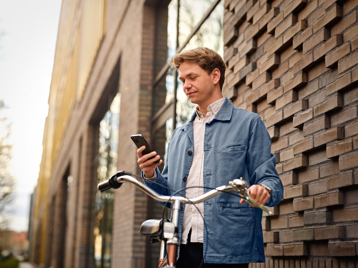 Lønbogholder læser nyhedsbrevet på sin smartphone